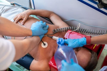 A medical professional assists an individual by placing an oxygen mask on their face, addressing a critical health need.